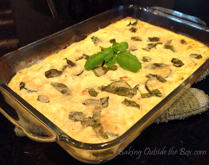 #bakingoutsidethebox | Simple ingredients combine to make a tangy and creamy baked zucchini casserole. Low Carb! Get the recipe.