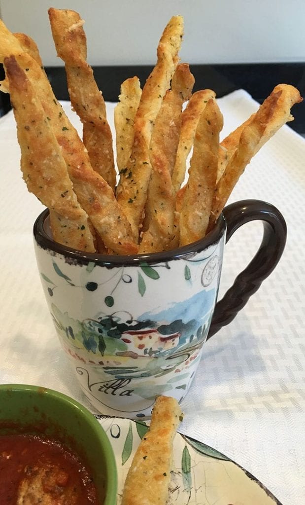 These Low Carb Italian Breadsticks are a satisfying savory treat. They bake up in about 30 minutes. They are crusty, chewy and flavorful. These breadsticks are a low carb bargain at just under 1 net carb each. #lowcarb #ketobread #italianbreadsticks #lowcarbbread #bakingoutsidethebox.com