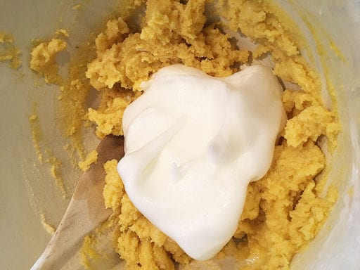 step 8. Put three spoonfuls of the whipped egg whites into the stiff batter and stir them in to ‘lighten up’ the batter.