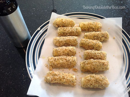 mozzarella sticks are prepped for the oven